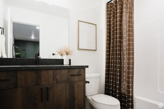 bathroom featuring toilet and vanity