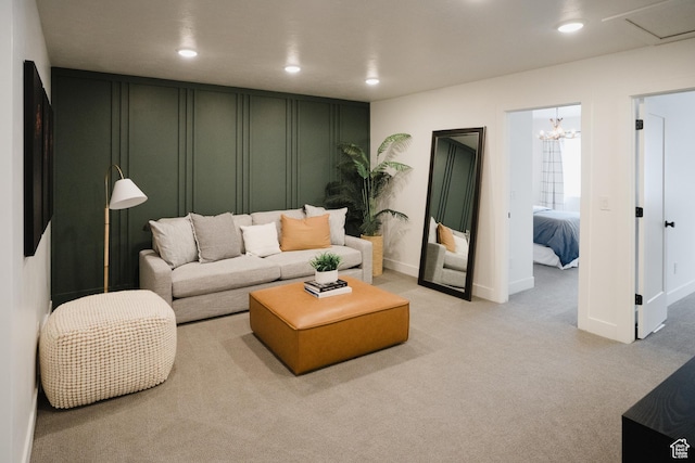 living room with a decorative wall, light colored carpet, and recessed lighting