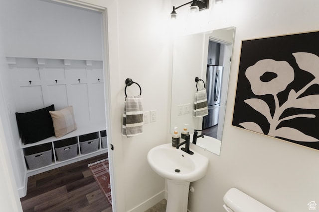 bathroom featuring toilet and wood finished floors