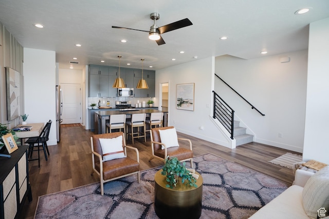 living area with recessed lighting, stairway, dark wood-style floors, and a ceiling fan