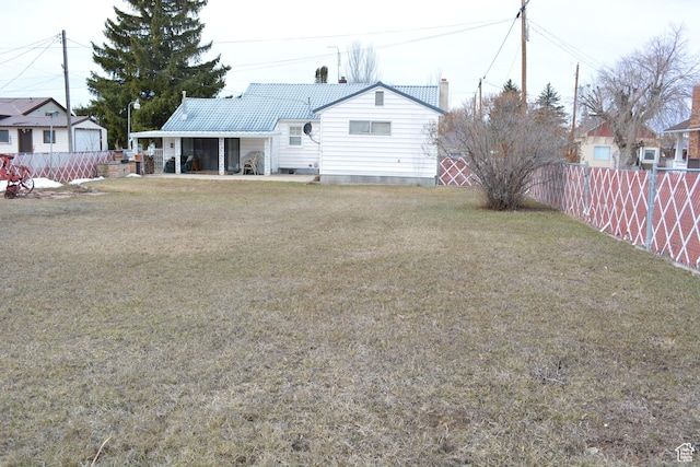 418 N 9th St, Montpelier, ID 83254 - rear view of house featuring a yard, a fenced backyard, and a chimney