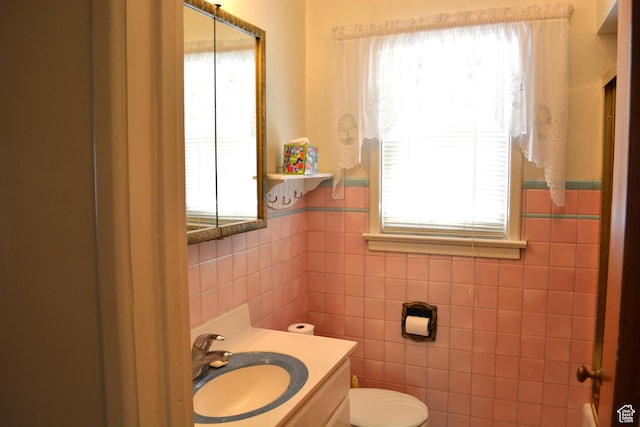 418 N 9th St, Montpelier, ID 83254 - bathroom with toilet, tile walls, and a wealth of natural light
