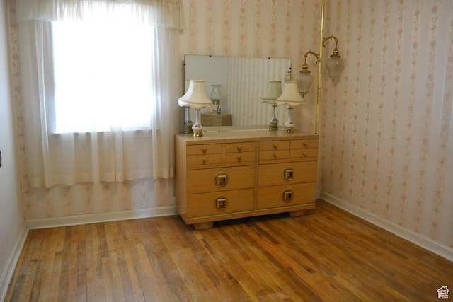 418 N 9th St, Montpelier, ID 83254 - unfurnished bedroom featuring light wood-style flooring, baseboards, and wallpapered walls
