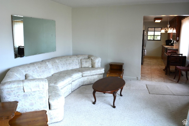 418 N 9th St, Montpelier, ID 83254 - living area featuring light carpet, light tile patterned floors, baseboards, and an inviting chandelier