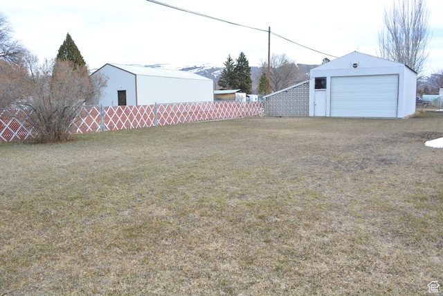 418 N 9th St, Montpelier, ID 83254 - view of yard with fence, an outbuilding, and a detached garage