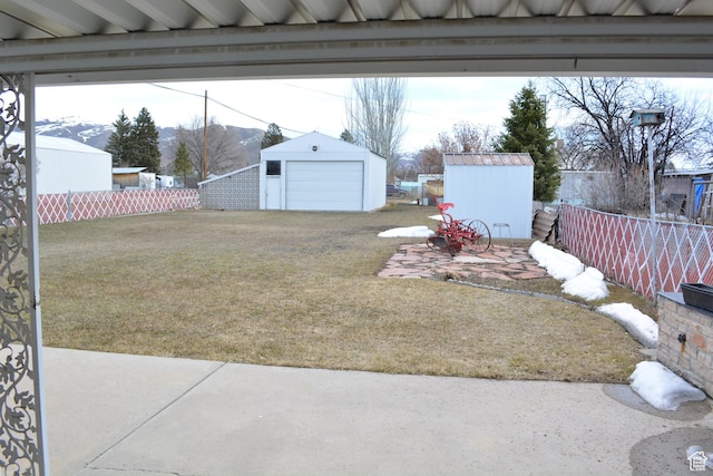418 N 9th St, Montpelier, ID 83254 - view of yard with a detached garage, fence, and an outdoor structure