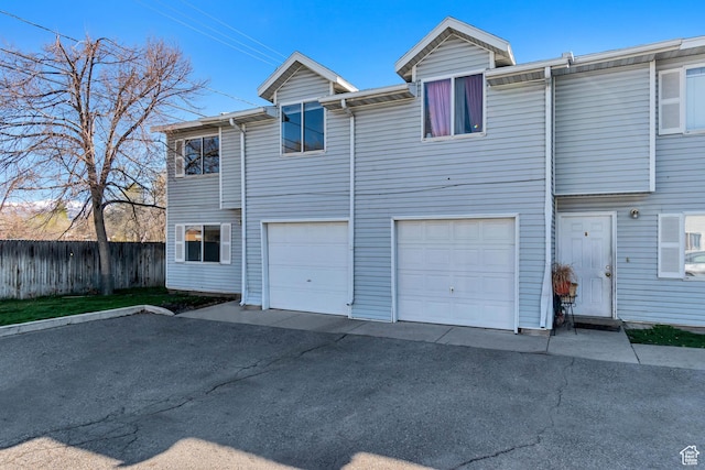 241 E Crestone Ave Unit 16A, South Salt Lake, UT 84115 - back of house with an attached garage, driveway, and fence