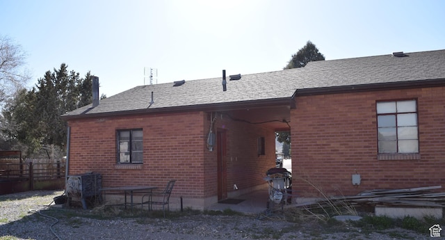 255 S Center St, Circleville, UT 84723 - back of property with brick siding, fence, and a shingled roof