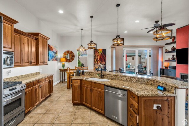 2090 N Tuweap Dr Unit 2, St George, UT 84770 - kitchen with ceiling fan with notable chandelier, a sink, stainless steel appliances, brown cabinets, and decorative backsplash