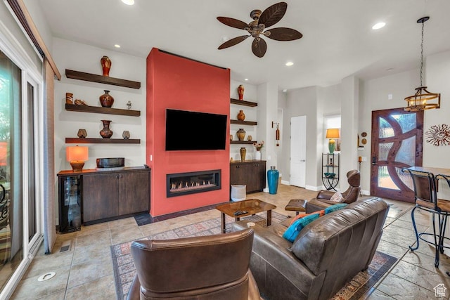 2090 N Tuweap Dr Unit 2, St George, UT 84770 - living area with built in features, baseboards, a fireplace, recessed lighting, and ceiling fan with notable chandelier