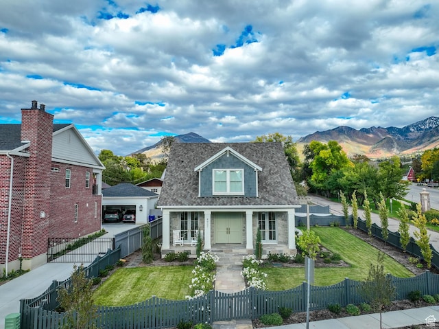 bungalow-style house with a mountain view, driveway, a fenced front yard, a front yard, and a gate
