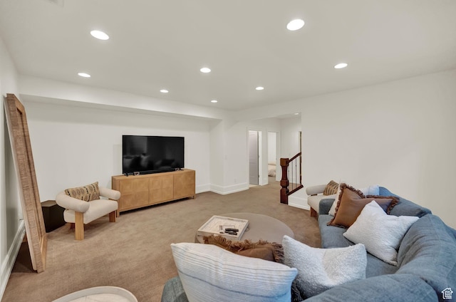 carpeted living area with baseboards, stairs, and recessed lighting