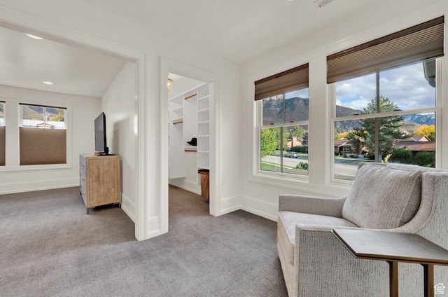 sitting room with baseboards, visible vents, and carpet floors