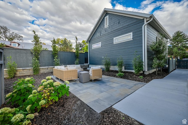 exterior space featuring a patio area, a fenced backyard, and an outdoor hangout area