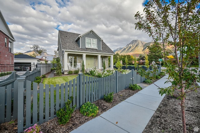 view of front of home featuring a mountain view and a fenced front yard