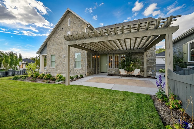 rear view of house with a pergola, a yard, a patio area, stone siding, and fence