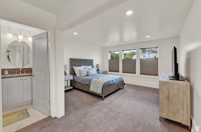 bedroom with recessed lighting, carpet flooring, a sink, and connected bathroom