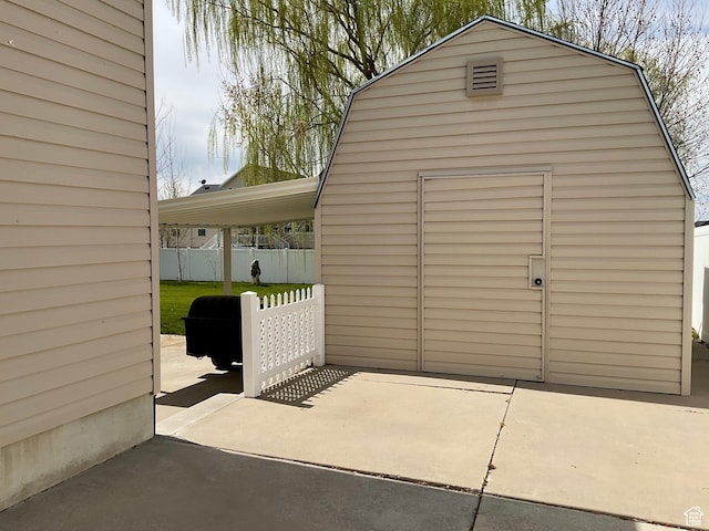 exterior space with fence and a storage unit