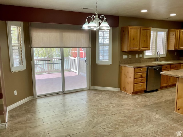 kitchen featuring a sink, baseboards, a chandelier, and dishwashing machine