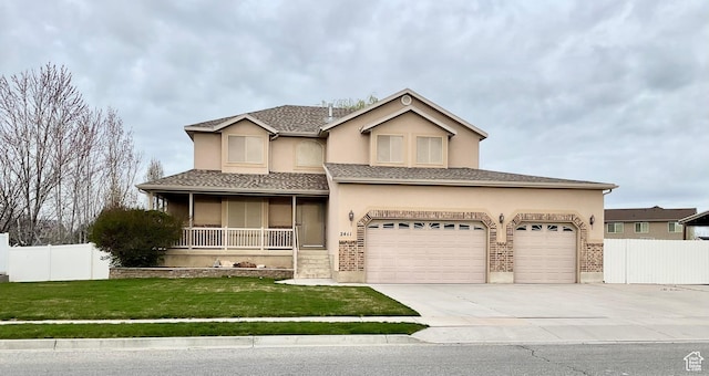 2461 N 2710 W, Clinton, UT 84015 - view of front of house with driveway, covered porch, stucco siding, and an attached garage