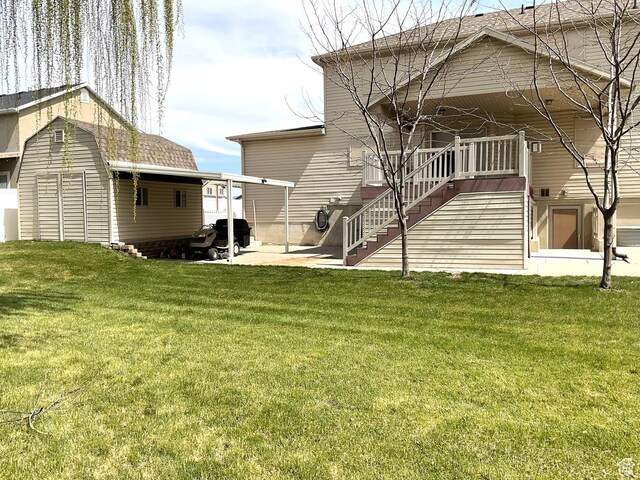 2461 N 2710 W, Clinton, UT 84015 - rear view of house featuring a lawn, stairs, and a patio