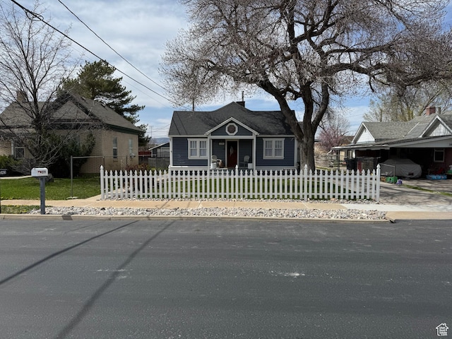 bungalow featuring a front yard and a fenced front yard