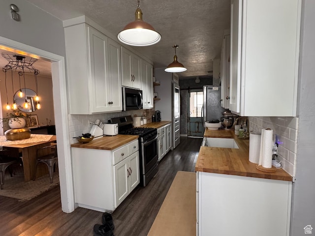 kitchen featuring white cabinetry, gas stove, dark wood-style flooring, wood counters, and backsplash