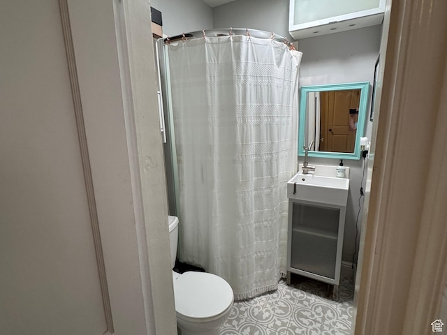 bathroom with tile patterned floors, toilet, vanity, and a shower with curtain