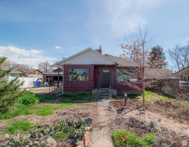 180 E Southgate Ave S, Salt Lake City, UT 84115 - rear view of house with fence and a chimney