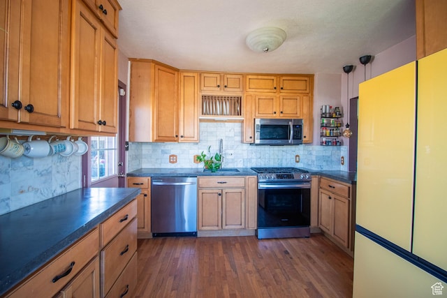 180 E Southgate Ave S, Salt Lake City, UT 84115 - kitchen with dark wood-type flooring, tasteful backsplash, appliances with stainless steel finishes, a sink, and dark countertops