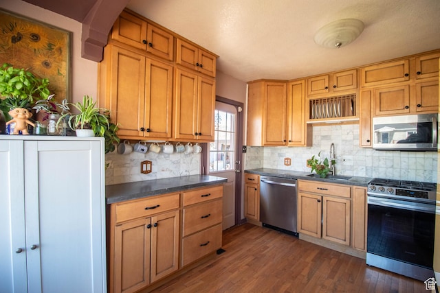 180 E Southgate Ave S, Salt Lake City, UT 84115 - kitchen featuring tasteful backsplash, dark wood-style floors, dark countertops, stainless steel appliances, and a sink