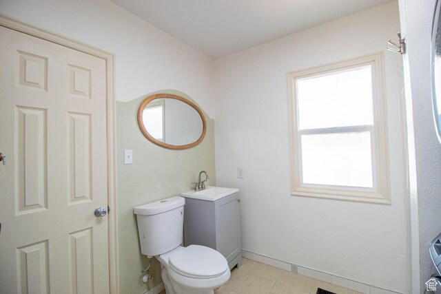 180 E Southgate Ave S, Salt Lake City, UT 84115 - bathroom with tile patterned flooring, baseboards, a sink, and toilet