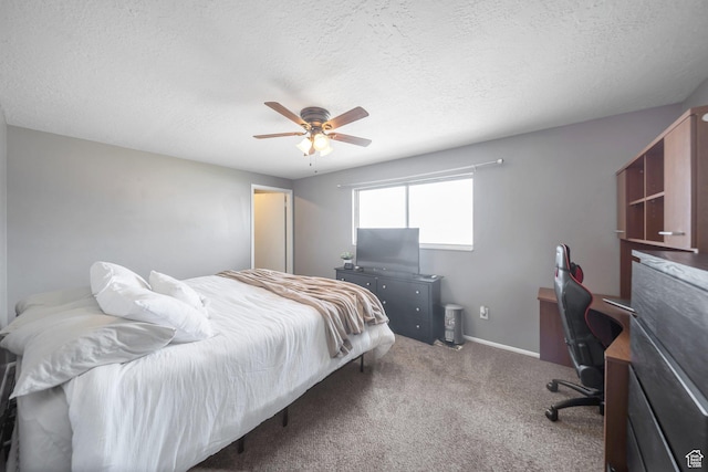 bedroom featuring ceiling fan, a textured ceiling, baseboards, and carpet floors
