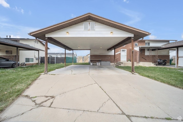 view of car parking featuring entry steps, fence, and driveway