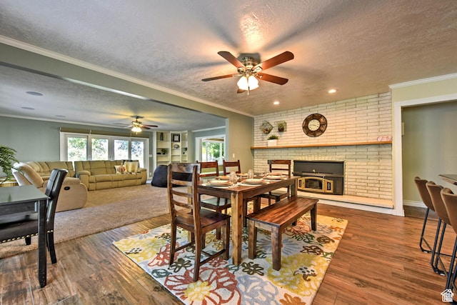 1050 S 200 W, Wellsville, UT 84339 - dining room with a ceiling fan, a fireplace, crown molding, a textured ceiling, and wood finished floors