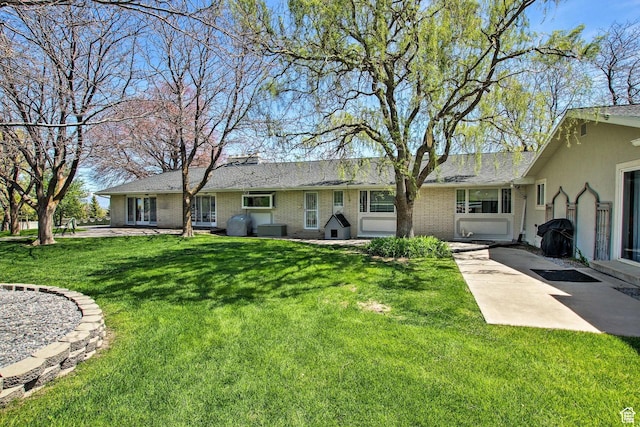 1050 S 200 W, Wellsville, UT 84339 - view of front of house featuring a front yard and brick siding