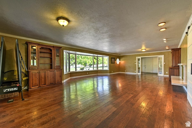 1050 S 200 W, Wellsville, UT 84339 - unfurnished living room featuring dark wood-type flooring, ornamental molding, baseboards, and a textured ceiling