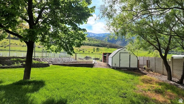 1050 S 200 W, Wellsville, UT 84339 - view of yard with an outdoor structure, a mountain view, fence, and a storage unit