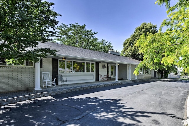 1050 S 200 W, Wellsville, UT 84339 - view of front of house with a chimney, a shingled roof, and brick siding
