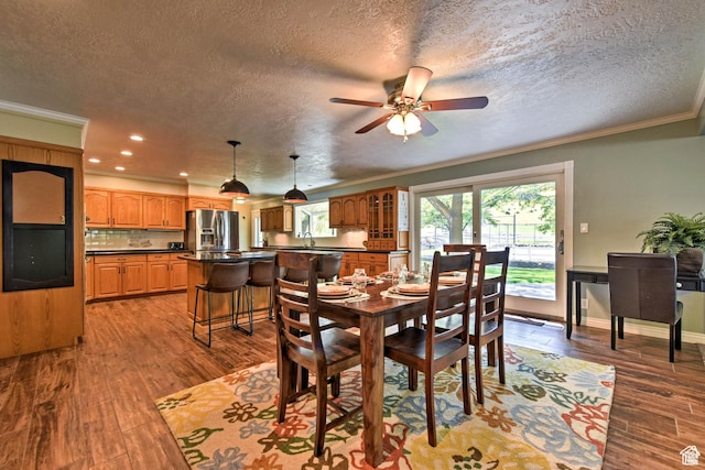 1050 S 200 W, Wellsville, UT 84339 - dining area with baseboards, a textured ceiling, a ceiling fan, crown molding, and light wood-style floors