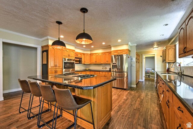 1050 S 200 W, Wellsville, UT 84339 - kitchen featuring stainless steel appliances, tasteful backsplash, a sink, and dark countertops
