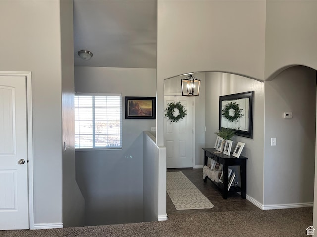 interior space with an inviting chandelier and baseboards