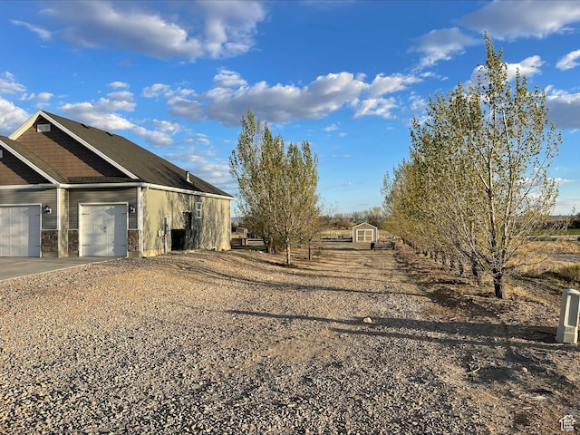 view of side of property with an attached garage and driveway