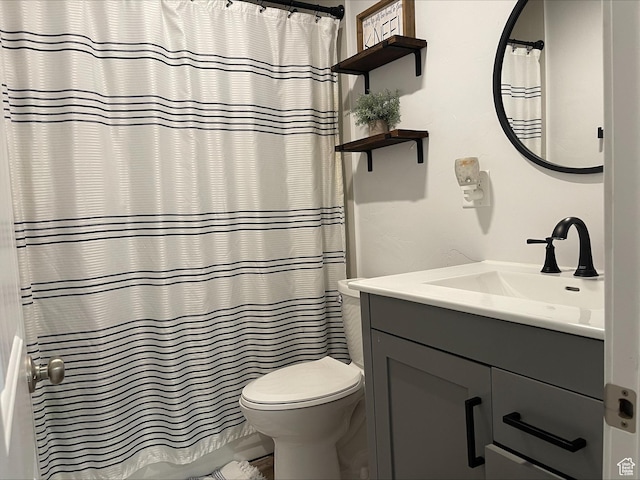 bathroom with vanity, toilet, and curtained shower