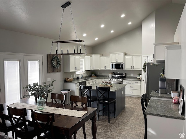 dining area with recessed lighting and high vaulted ceiling