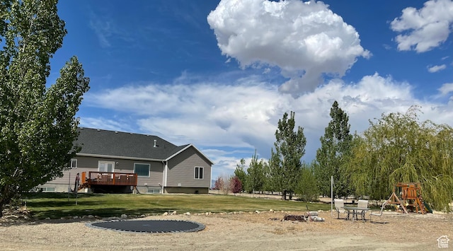view of yard with a playground and a deck