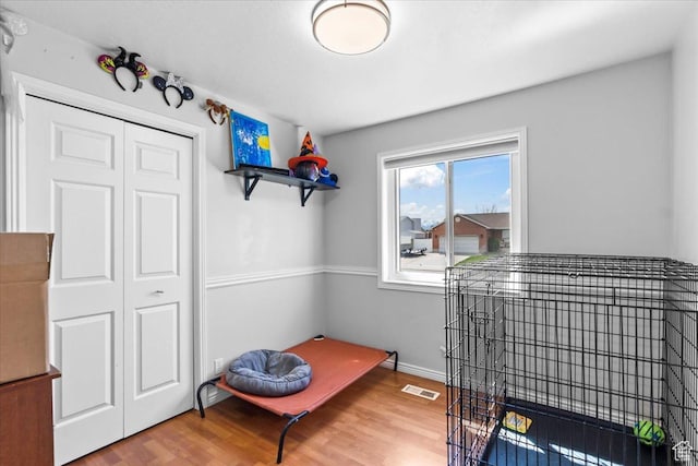 interior space featuring visible vents, baseboards, and wood finished floors