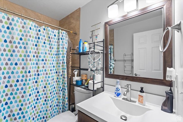 bathroom with toilet, curtained shower, and vanity