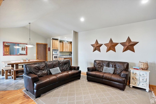 living room featuring light wood-style flooring and lofted ceiling