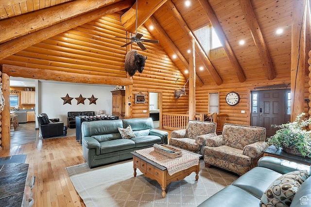 living room with log walls, a ceiling fan, wood ceiling, beam ceiling, and hardwood / wood-style floors